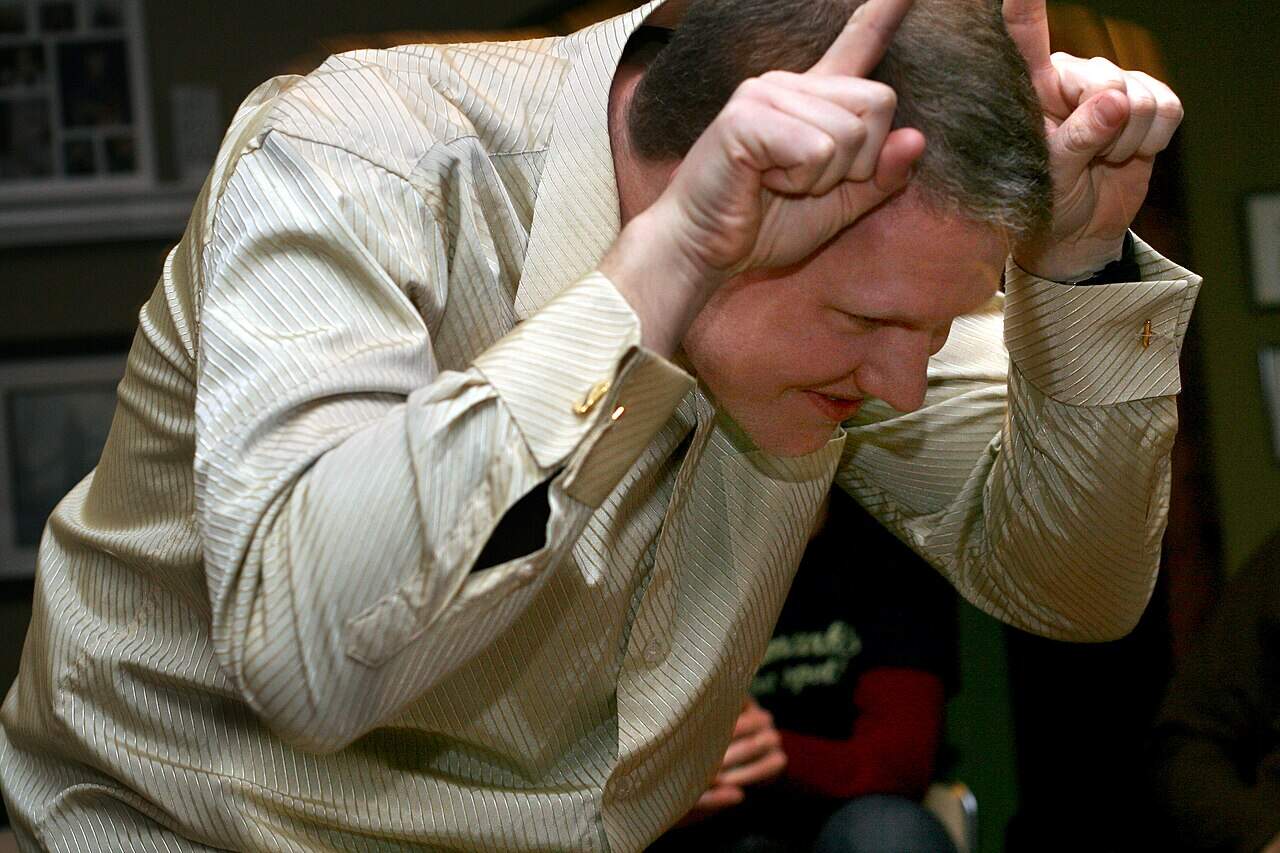 employee participating in charades as part of an indoor team building activity